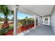 Covered front porch with decorative columns and view of manicured lawn at 916 Sago Palm Way, Apollo Beach, FL 33572