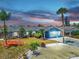 Charming single-story home features a well-manicured lawn, beautiful landscaping and a two-car garage at 916 Sago Palm Way, Apollo Beach, FL 33572