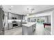 Modern kitchen featuring gray cabinets, stainless steel appliances, and an island with counter seating at 916 Sago Palm Way, Apollo Beach, FL 33572