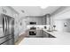 This kitchen features stainless steel appliances, grey cabinets, and white countertops at 916 Sago Palm Way, Apollo Beach, FL 33572