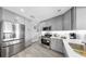 Well-lit kitchen featuring stainless steel appliances, grey cabinets, and white countertops at 916 Sago Palm Way, Apollo Beach, FL 33572