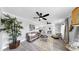 Inviting living space with gray wood-look floors and views into the dining and kitchen areas at 916 Sago Palm Way, Apollo Beach, FL 33572