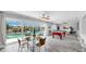 Open-concept living and dining area with a view of the sparkling pool and lush landscaping at 916 Sago Palm Way, Apollo Beach, FL 33572