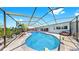 Spacious screened-in pool area with brick pavers and patio furniture for outdoor enjoyment at 916 Sago Palm Way, Apollo Beach, FL 33572