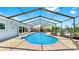 Beautifully designed screened-in pool with brick pavers, offering a perfect outdoor living space at 916 Sago Palm Way, Apollo Beach, FL 33572