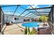 Screened-in outdoor pool area features a large pool, seating and lush tropical landscaping at 916 Sago Palm Way, Apollo Beach, FL 33572