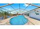 Backyard pool area and surrounding canal views with a caged enclosure at 916 Sago Palm Way, Apollo Beach, FL 33572