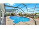Enclosed pool features a lovely waterfront view and outdoor seating area at 916 Sago Palm Way, Apollo Beach, FL 33572