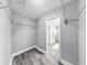 Walk-in closet with white wire shelving and access to the ensuite bathroom at 916 Sago Palm Way, Apollo Beach, FL 33572
