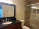 Bathroom features a vanity with a sleek black countertop and enclosed glass shower stall at 9481 Highland Oak Dr # 814, Tampa, FL 33647