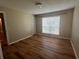 Comfortable bedroom with wood floors, a window, and a closet, providing a functional and relaxing retreat at 9481 Highland Oak Dr # 814, Tampa, FL 33647