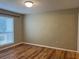 A bedroom with sleek hardwood floors, natural light and a minimalist aesthetic at 9481 Highland Oak Dr # 814, Tampa, FL 33647
