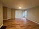 Spacious living room with light walls, wood floors, and sliding doors that brings in plenty of natural light at 9481 Highland Oak Dr # 814, Tampa, FL 33647