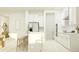 Well-lit kitchen with stainless steel appliances, white cabinetry, island with seating at 9545 Minnow Ray Dr, Land O Lakes, FL 34638