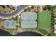 Aerial view of community tennis and basketball courts near a scenic lake at 9931 Victory Gallop Loop, Ruskin, FL 33573