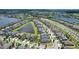 Beautiful aerial shot of a residential neighborhood with manicured lawns, peaceful ponds, and convenient road access at 9931 Victory Gallop Loop, Ruskin, FL 33573