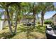 Backyard featuring a pergola with outdoor seating and lush palm trees at 9931 Victory Gallop Loop, Ruskin, FL 33573