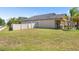 Spacious backyard with a well-maintained lawn and a privacy fence at 9931 Victory Gallop Loop, Ruskin, FL 33573
