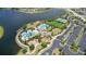 Aerial view of community amenities including pools, playground, clubhouse, tennis courts, and parking area near a lake at 9931 Victory Gallop Loop, Ruskin, FL 33573
