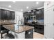 Modern kitchen featuring granite countertops, stainless steel appliances, and dark cabinetry at 9931 Victory Gallop Loop, Ruskin, FL 33573