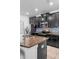 Modern kitchen featuring granite countertops, stainless steel appliances, and dark cabinetry at 9931 Victory Gallop Loop, Ruskin, FL 33573