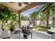 Relaxing outdoor patio featuring tile flooring, seating, and lush tropical foliage at 9931 Victory Gallop Loop, Ruskin, FL 33573