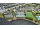Aerial view of community tennis and basketball courts next to a lake, parking and green space at 9931 Victory Gallop Loop, Ruskin, FL 33573