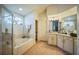 Bathroom featuring a separate shower and tub with natural tile and ample vanity space at 1007 English Bluffs Ct, Brandon, FL 33511