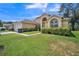 Well-maintained single-story home boasting a manicured lawn, attached garage, and beautiful landscaping at 1007 English Bluffs Ct, Brandon, FL 33511