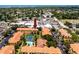 Aerial view of the complex showcasing the beautiful landscaping, pool, and tennis court amenities at 10764 70Th Ave # 5302, Seminole, FL 33772