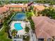 Aerial view of the condo community showcasing the pool and tennis courts at 10764 70Th Ave # 5302, Seminole, FL 33772