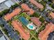 Aerial view of complex highlighting the tennis court, pool, landscaping, and ample parking at 10764 70Th Ave # 5302, Seminole, FL 33772