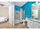 Bathroom with blue accent wall has shower and tub combo at 10764 70Th Ave # 5302, Seminole, FL 33772