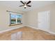 Comfortable bedroom featuring tile floors, a ceiling fan, and a bright window at 10764 70Th Ave # 5302, Seminole, FL 33772