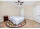 Bedroom with neutral walls and decor features tile flooring and a ceiling fan at 10764 70Th Ave # 5302, Seminole, FL 33772