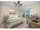 Comfortable bedroom features a ceiling fan, a well-lit desk, and natural light at 10764 70Th Ave # 5302, Seminole, FL 33772