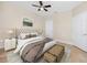 Bedroom featuring a tufted headboard, ceiling fan, and plenty of closet space at 10764 70Th Ave # 5302, Seminole, FL 33772