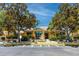 View of the clubhouse exterior surrounded by mature shade trees and landscaping at 10764 70Th Ave # 5302, Seminole, FL 33772