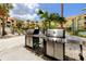 Convenient outdoor grilling area with modern stainless steel grills and well-maintained landscaping at 10764 70Th Ave # 5302, Seminole, FL 33772