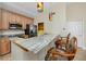 Kitchen island with stainless steel appliances, wood cabinets, bar stool seating and granite countertops at 10764 70Th Ave # 5302, Seminole, FL 33772