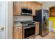 Well-equipped kitchen featuring stainless steel appliances, granite countertops, and wood cabinets at 10764 70Th Ave # 5302, Seminole, FL 33772