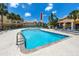 Inviting swimming pool surrounded by lounge chairs and palm trees in a vibrant community setting at 10764 70Th Ave # 5302, Seminole, FL 33772