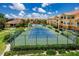 Aerial view of the community tennis courts with meticulously maintained landscaping at 10764 70Th Ave # 5302, Seminole, FL 33772