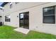 Exterior backyard featuring a sliding glass door and grassy area at 11006 Tahiti Isle Ln, Tampa, FL 33647