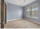 Bedroom features wood-look flooring and a sunlit window at 11006 Tahiti Isle Ln, Tampa, FL 33647