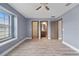 Large bedroom featuring wood-look flooring, a ceiling fan, and access to the bathroom and closet at 11006 Tahiti Isle Ln, Tampa, FL 33647