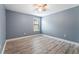 Cozy bedroom featuring wood-look flooring, a ceiling fan, and a window that provides natural light at 11006 Tahiti Isle Ln, Tampa, FL 33647