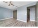 Bedroom featuring a ceiling fan, wood-look flooring, and access to the closet at 11006 Tahiti Isle Ln, Tampa, FL 33647