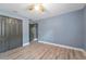 Bedroom with wood-look flooring, ceiling fan, and a closet to store all your belongings at 11006 Tahiti Isle Ln, Tampa, FL 33647