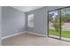 Bedroom with sliding glass doors leading to the backyard at 11006 Tahiti Isle Ln, Tampa, FL 33647